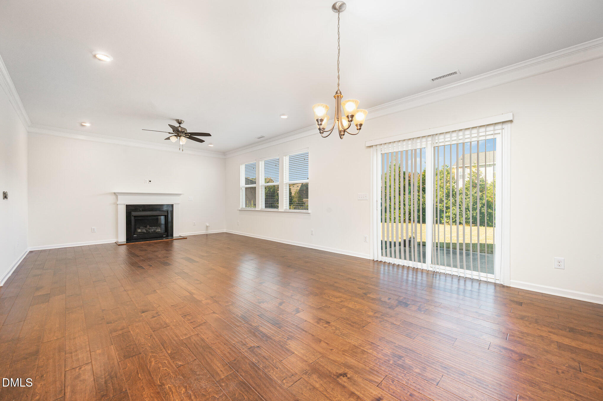 104 Oak Rise Lane Fuquay-Varina, NC 27526 - Photo 4 of 29 a view of an empty room with wooden floor fireplace and a window
