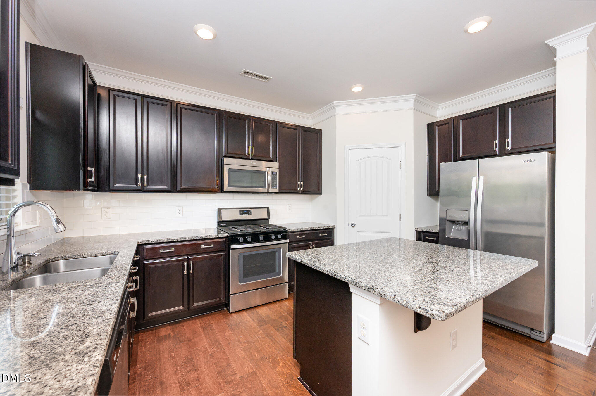 104 Oak Rise Lane Fuquay-Varina, NC 27526 - Photo 6 of 29 a kitchen with stainless steel appliances granite countertop a sink stove and refrigerator