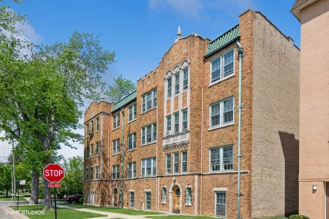 a view of a brick building next to a yard