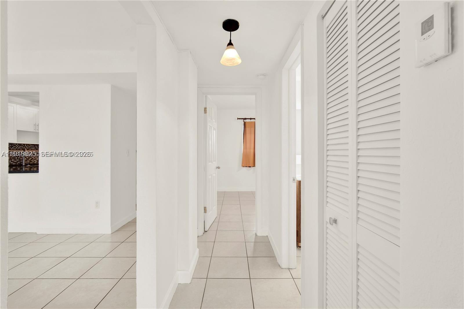 1990 West 56th Street, Unit 1407 Hialeah, FL 33012 - Photo 14 of 28 a view of a hallway with closet