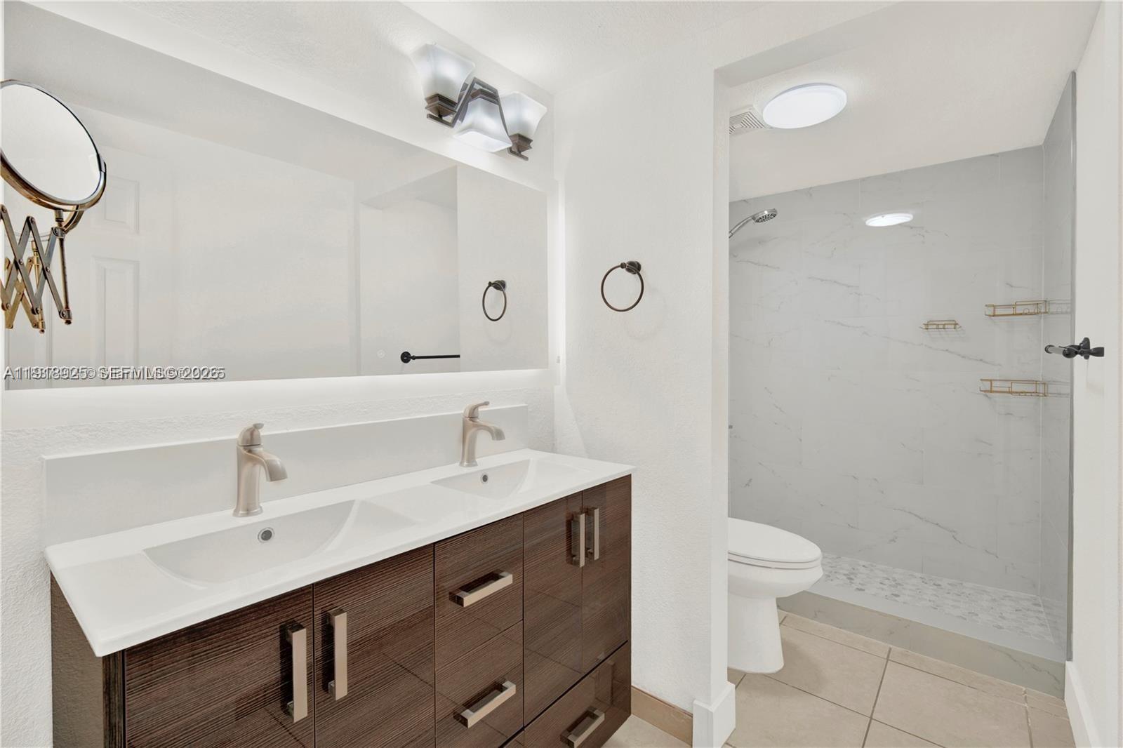 1990 West 56th Street, Unit 1407 Hialeah, FL 33012 - Photo 15 of 28 a bathroom with a sink shower and a mirror