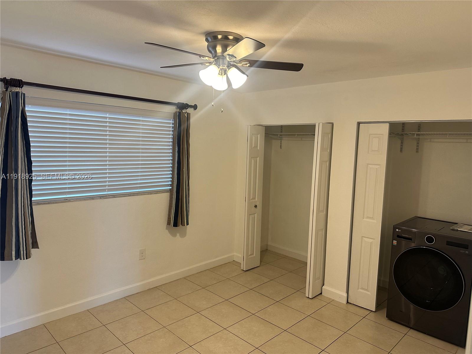 1990 West 56th Street, Unit 1407 Hialeah, FL 33012 - Photo 23 of 28 a view of a livingroom with a ceiling fan and a window