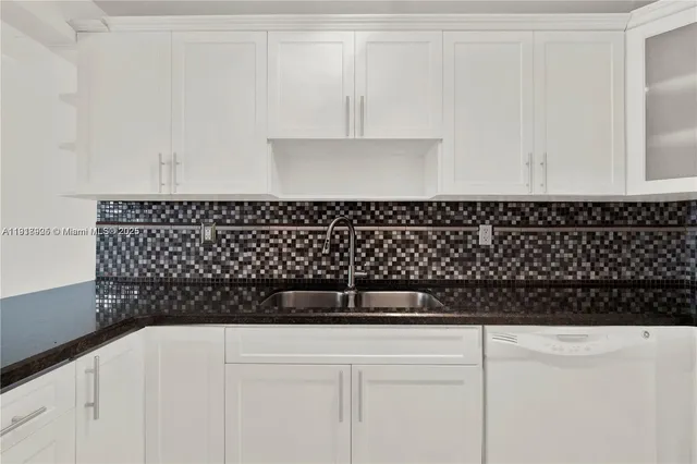 a view of an empty room and chandelier fan