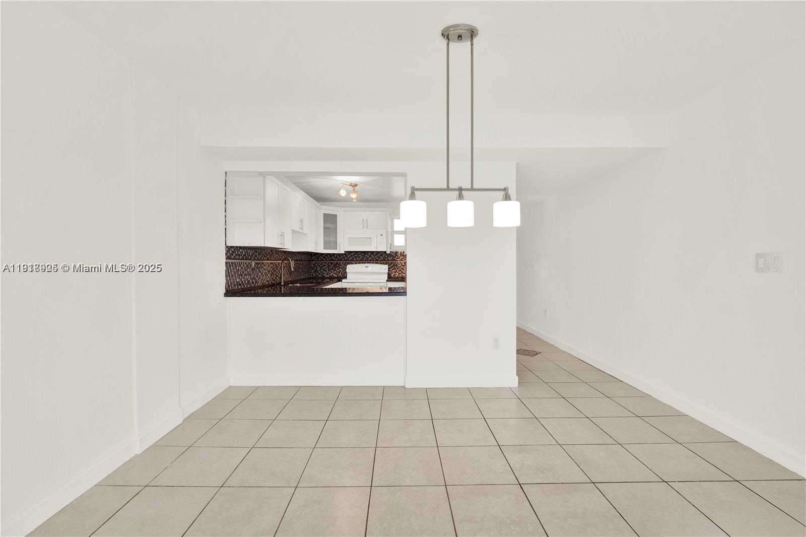 1990 West 56th Street, Unit 1407 Hialeah, FL 33012 - Photo 5 of 15 a view of an empty room and chandelier fan