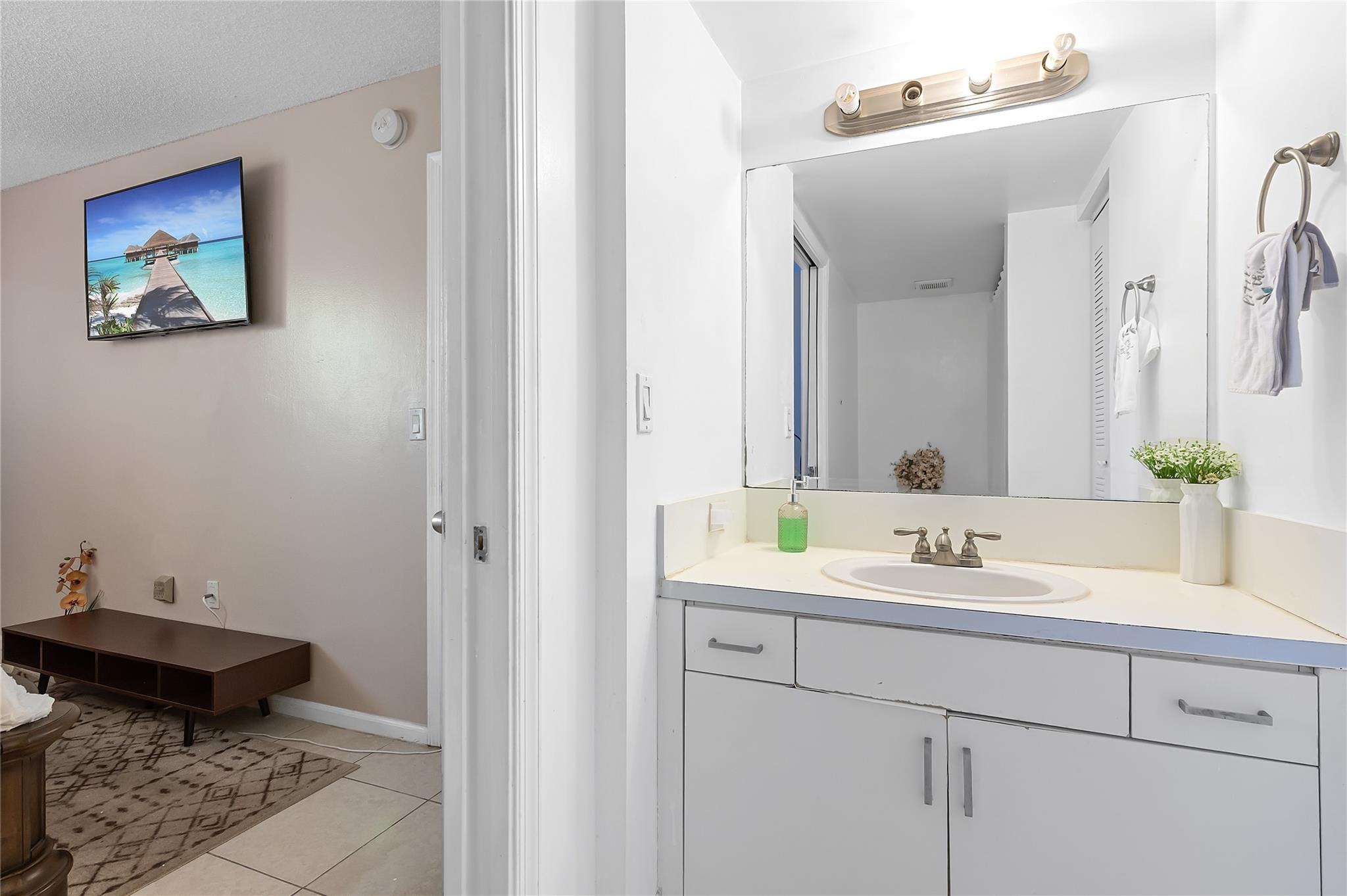 2133 Renaissance Boulevard, Unit 205 Miramar, FL 33025 - Photo 11 of 24 a bathroom with a sink and a mirror