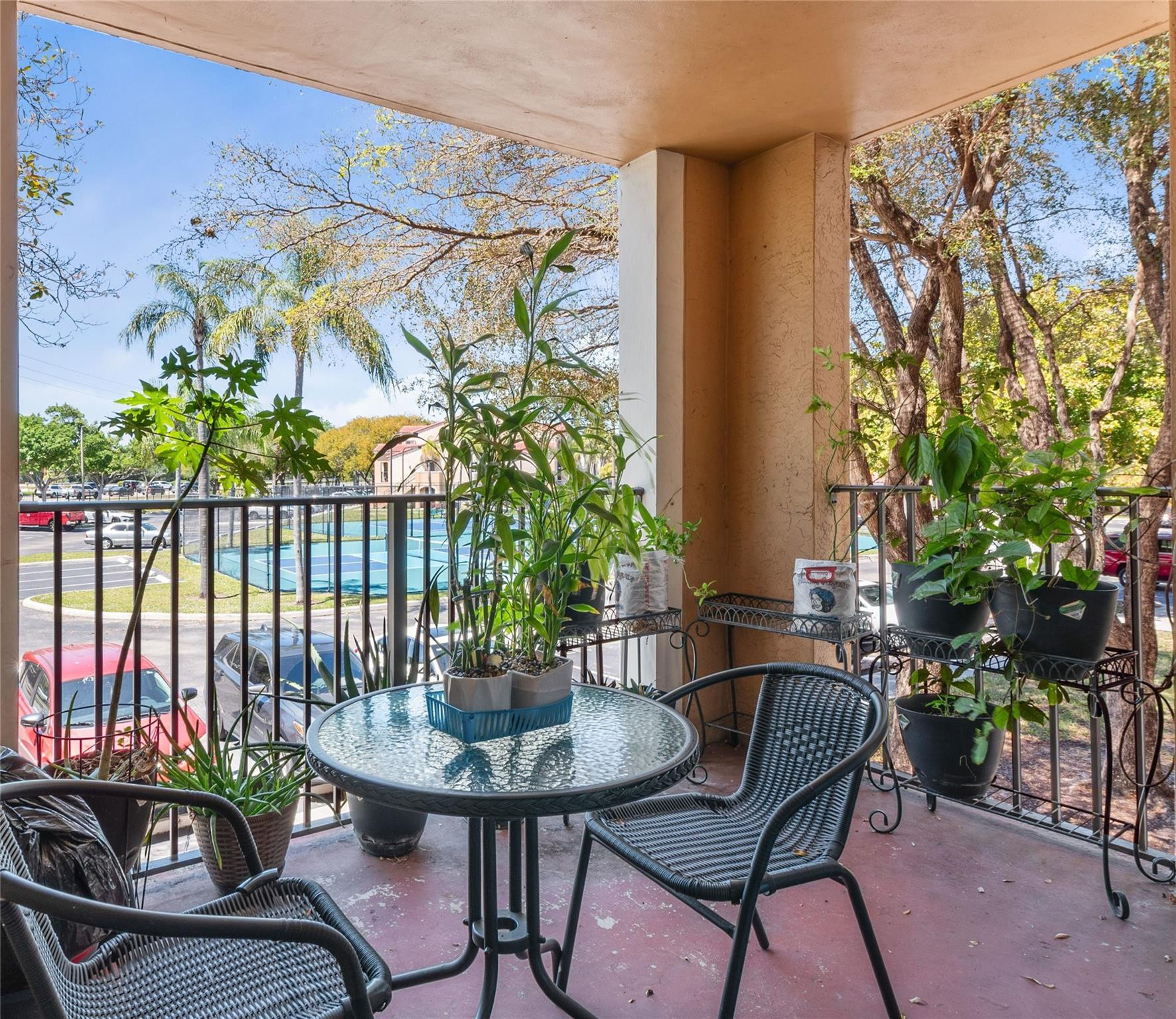 2133 Renaissance Boulevard, Unit 205 Miramar, FL 33025 - Photo 18 of 24 a view of a balcony with chairs and potted plants