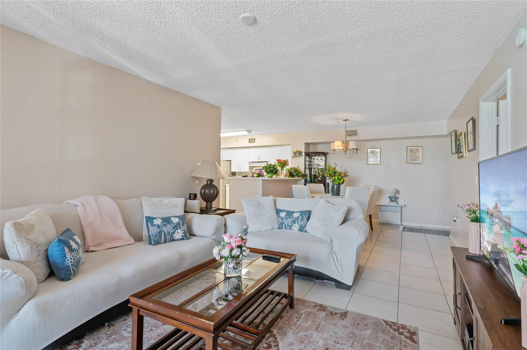 2133 Renaissance Boulevard, Unit 205 Miramar, FL 33025 - Photo 4 of 24 a living room with furniture and a rug