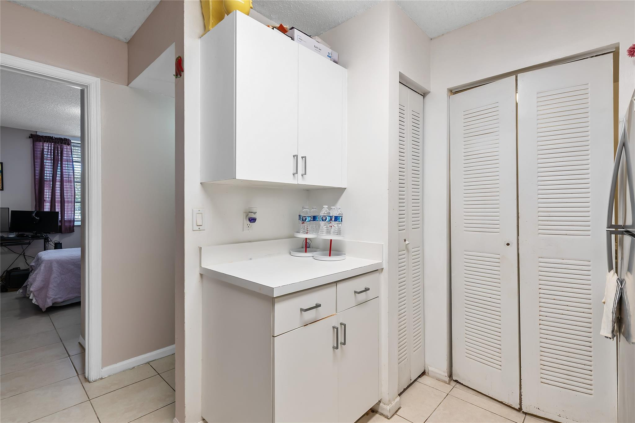 2133 Renaissance Boulevard, Unit 205 Miramar, FL 33025 - Photo 7 of 24 a view of a hallway to closet and utility room