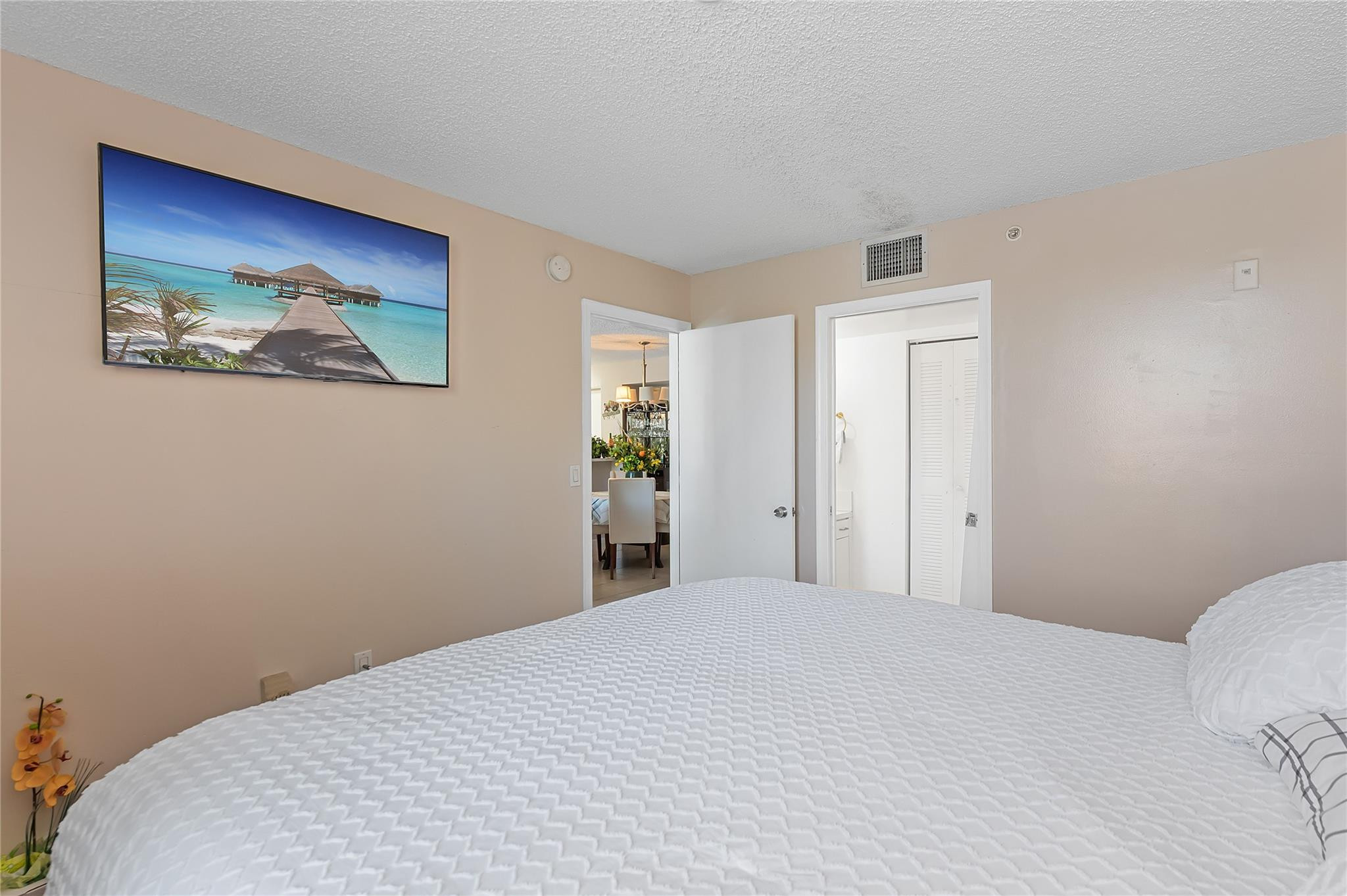 2133 Renaissance Boulevard, Unit 205 Miramar, FL 33025 - Photo 10 of 24 a bedroom with a bed and a painting on the wall