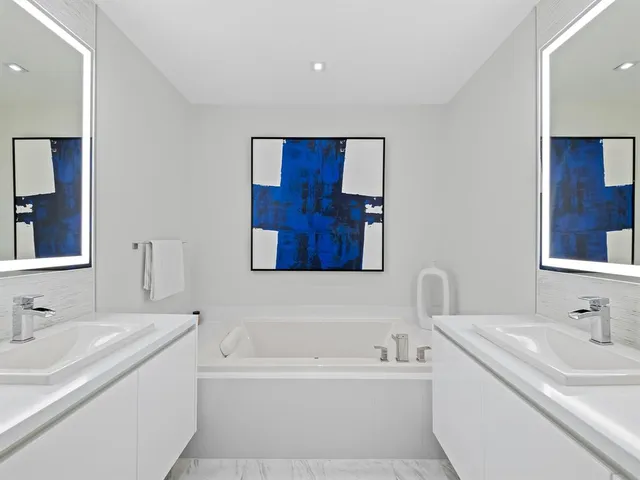 a bathroom with a tub sink and mirror