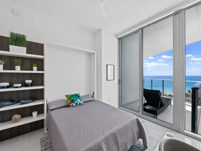 a bedroom with a bed window and book shelf