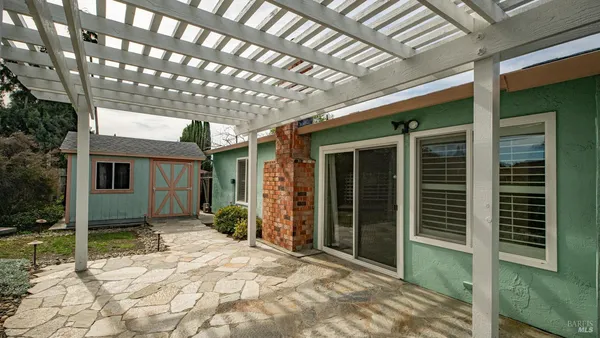 a view of house with backyard and glass windows