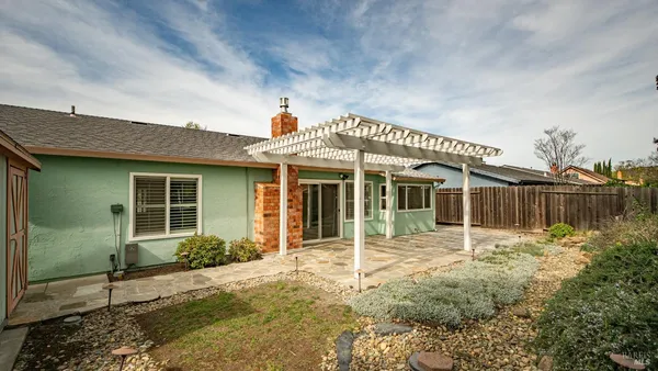 a front view of a house with a garden