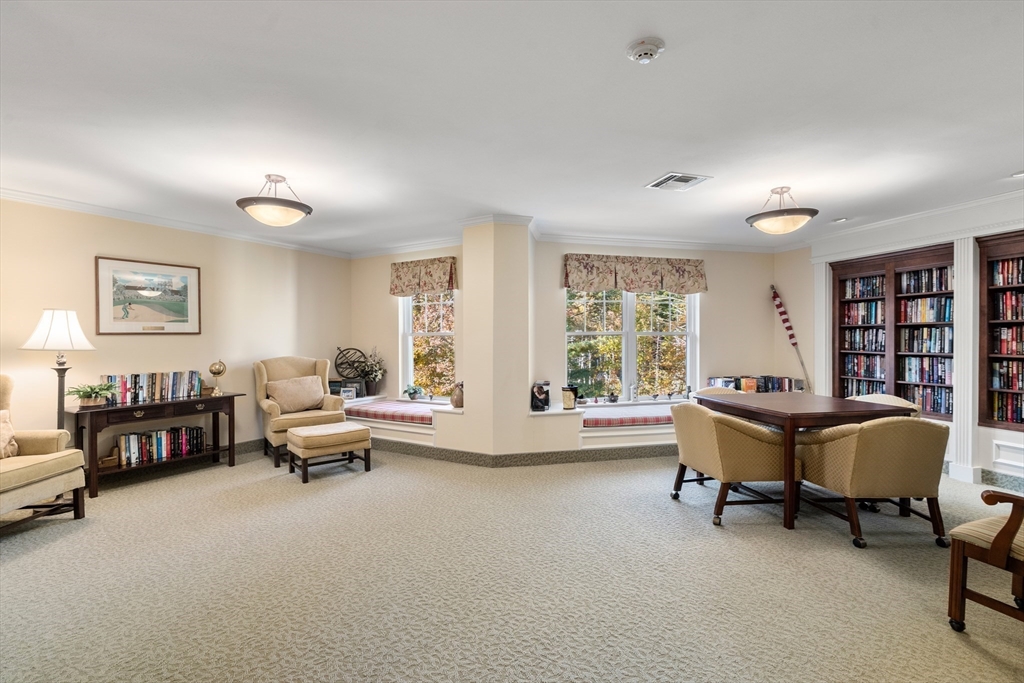 7 Crescent Way, Unit 105 Sturbridge, MA 01518 - Photo 14 of 35 a living room with furniture and a large window