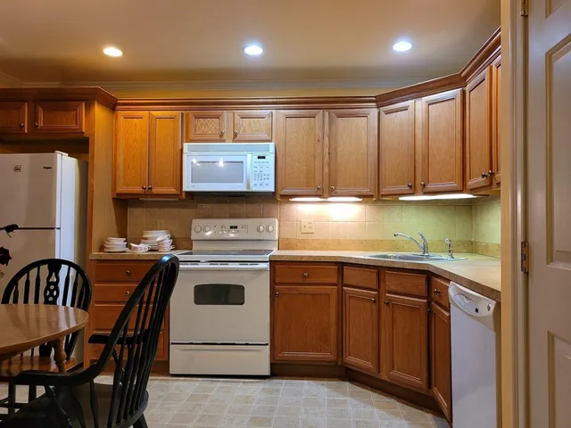 a kitchen with a stove a refrigerator and a sink