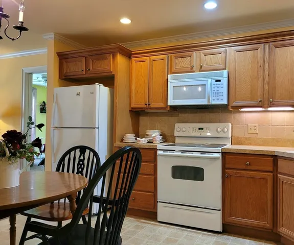 a view of kitchen with stainless steel appliances wooden cabinets and a sink