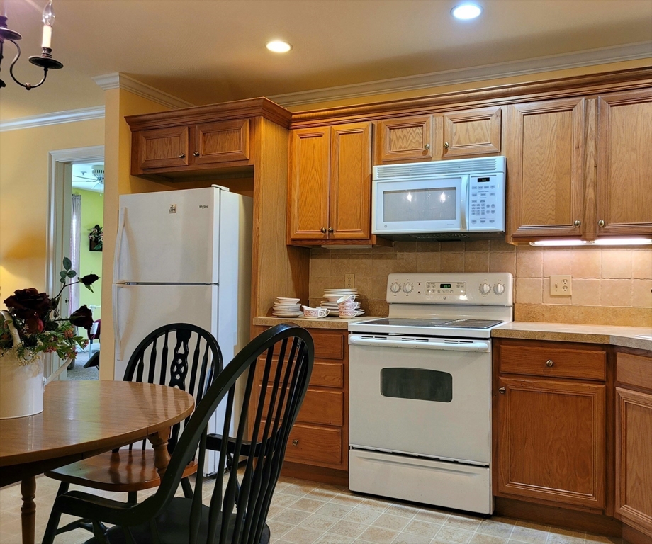7 Crescent Way, Unit 105 Sturbridge, MA 01518 - Photo 21 of 35 a kitchen with a stove a refrigerator and a sink