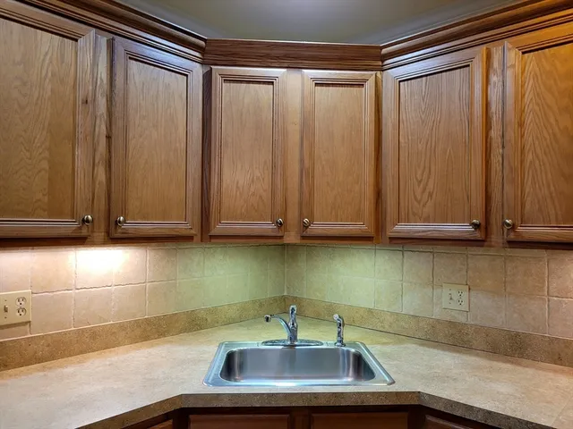 a view of a dining room with furniture and a chandelier