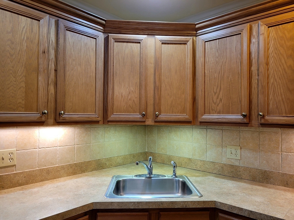 7 Crescent Way, Unit 105 Sturbridge, MA 01518 - Photo 22 of 35 a view of kitchen with stainless steel appliances wooden cabinets and a sink