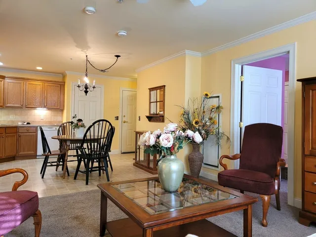 a view of a dining room with furniture and a chandelier
