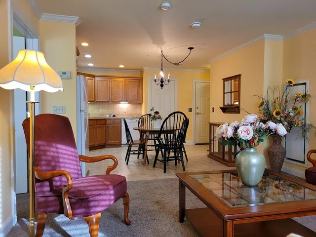 a view of a dining room with furniture and a chandelier