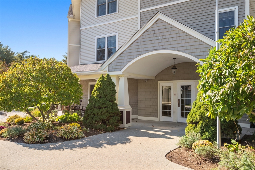 7 Crescent Way, Unit 105 Sturbridge, MA 01518 - Photo 3 of 35 a view of a white house next to a yard