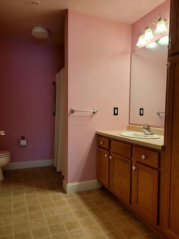 7 Crescent Way, Unit 105 Sturbridge, MA 01518 - Photo 32 of 35 a bathroom with a sink and a mirror