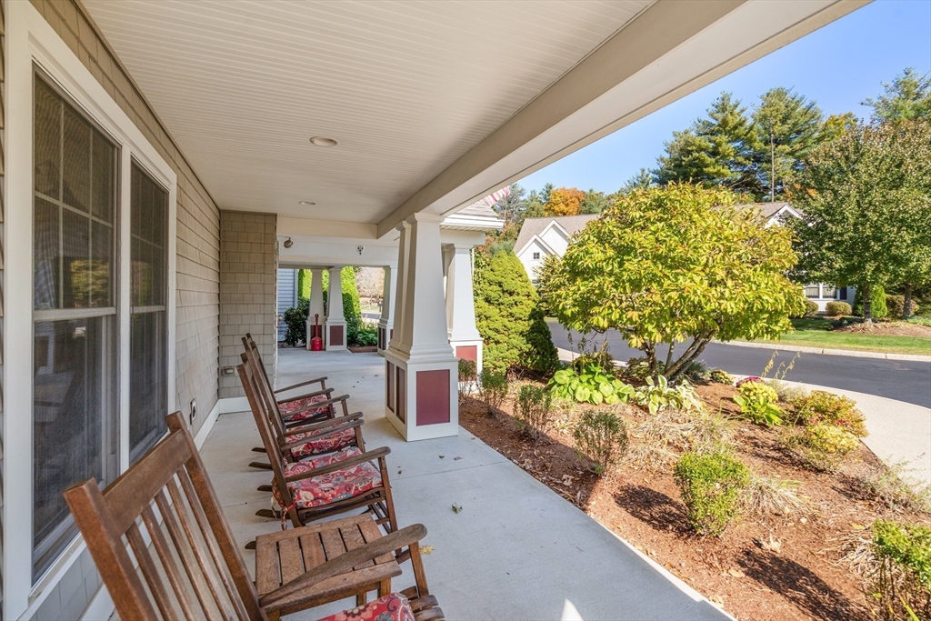 7 Crescent Way, Unit 105 Sturbridge, MA 01518 - Photo 35 of 35 a balcony with chairs and a table