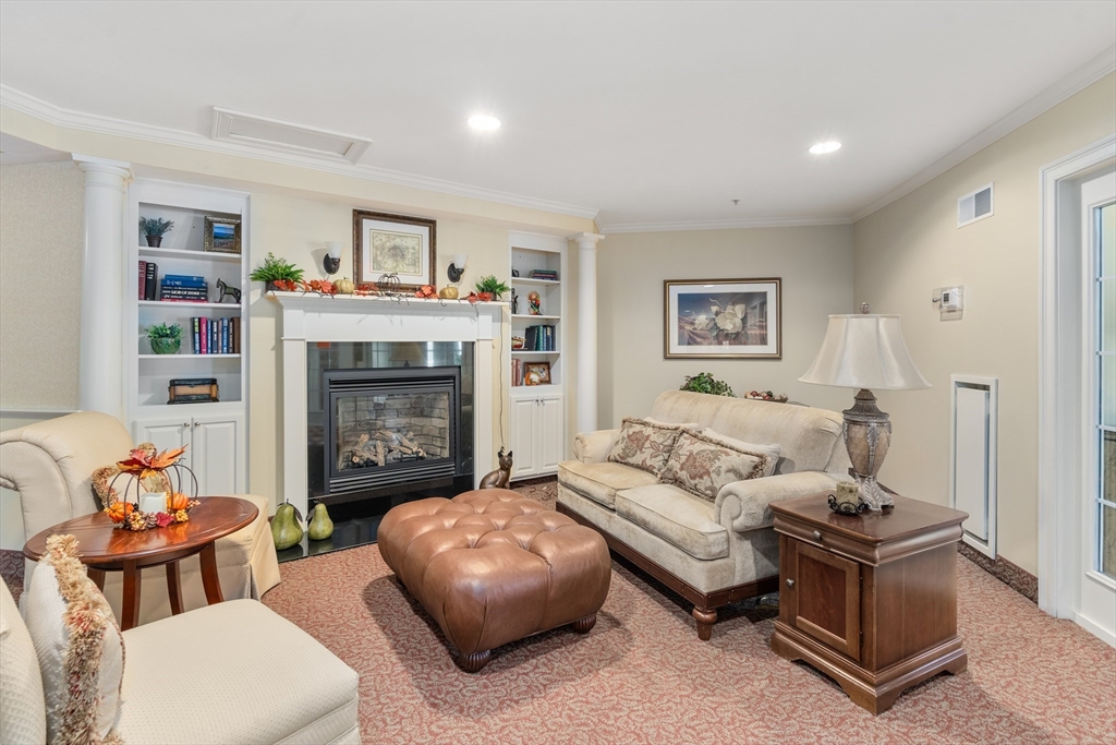 7 Crescent Way, Unit 105 Sturbridge, MA 01518 - Photo 4 of 35 a living room with furniture and a fireplace
