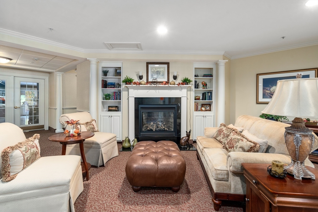 7 Crescent Way, Unit 105 Sturbridge, MA 01518 - Photo 5 of 35 a living room with furniture and a fireplace