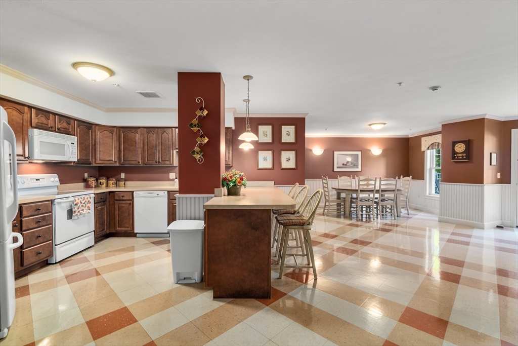 7 Crescent Way, Unit 105 Sturbridge, MA 01518 - Photo 7 of 35 a kitchen with a sink cabinets and stainless steel appliances