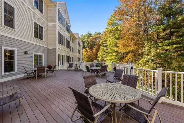 a view of a patio with table and chairs and wooden floor