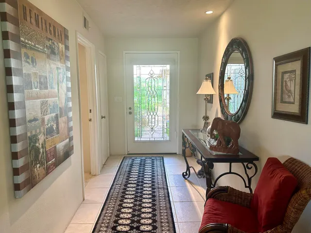 a living room filled with furniture and a chandelier