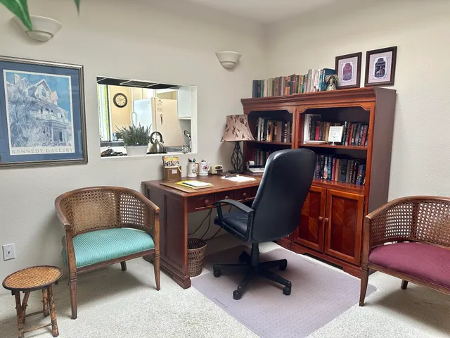 a kitchen with stainless steel appliances granite countertop a stove a refrigerator a sink and white cabinets