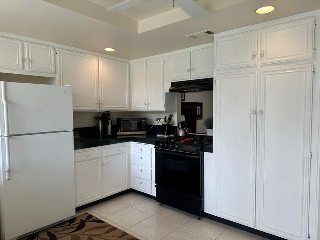 a bedroom with a bed a couch and a walk in closet