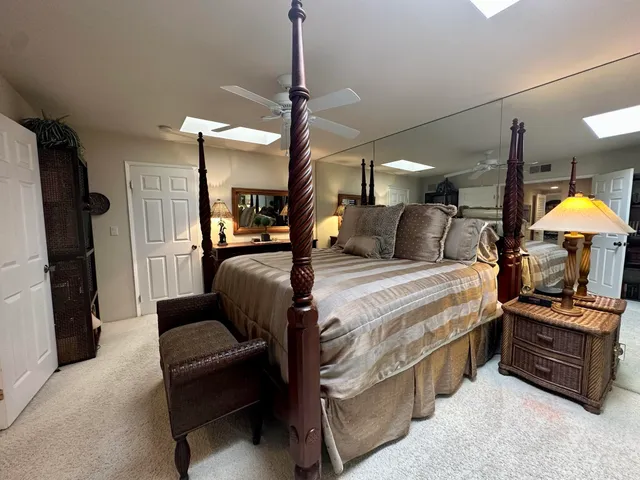 a spacious bathroom with a mirror sink and shower
