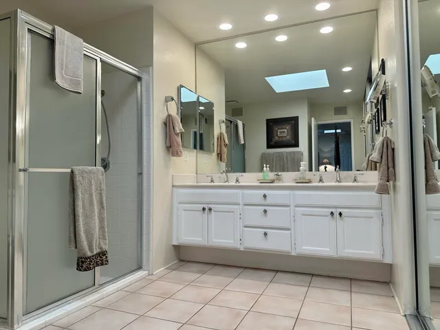 a bedroom with a bed and large mirror