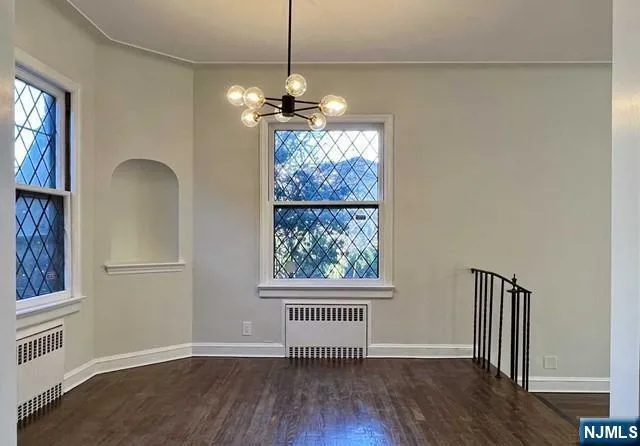 a kitchen with granite countertop a refrigerator sink and cabinets