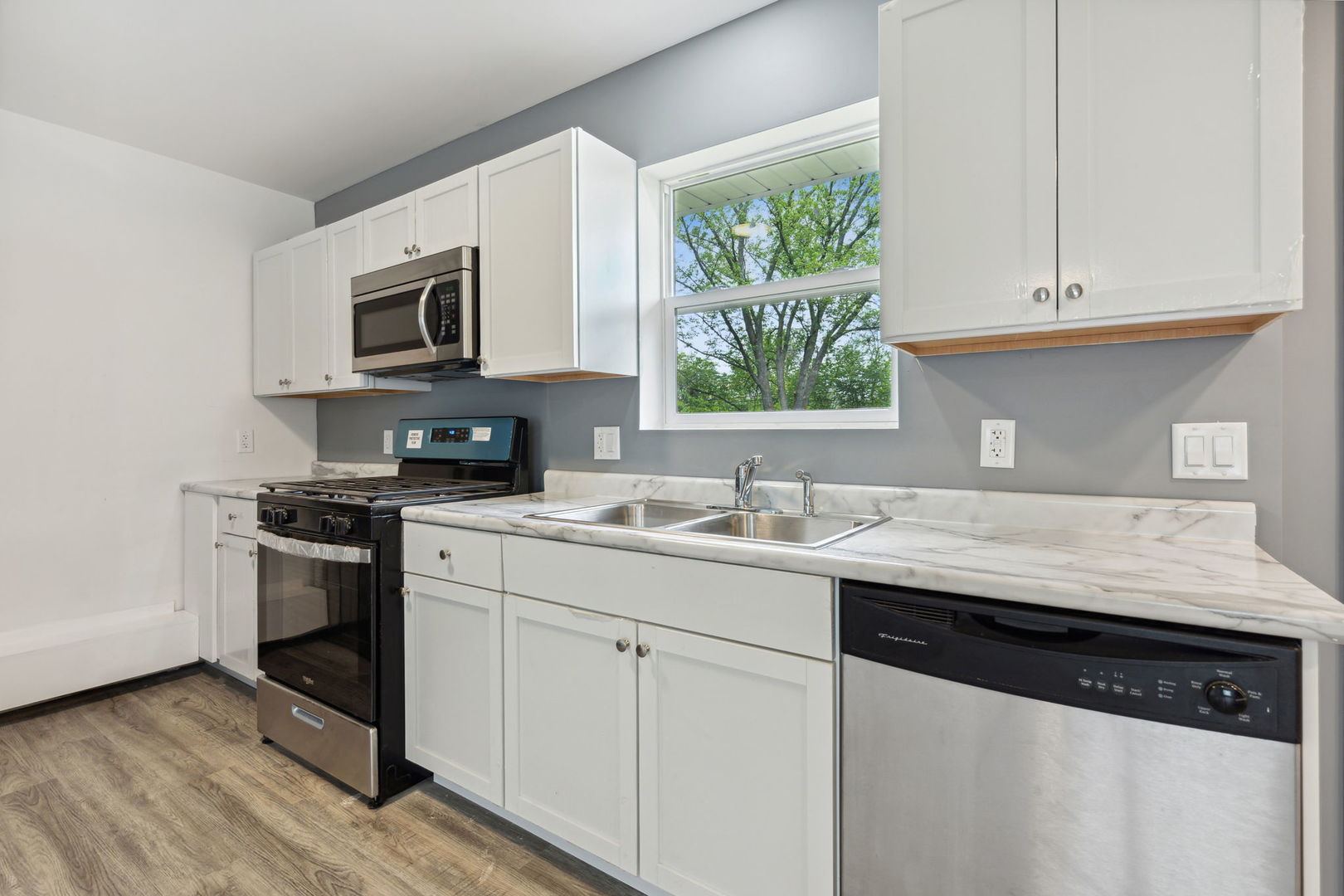 Undisclosed Address Chicago Heights, IL 60411 - Photo 11 of 20 a kitchen with stainless steel appliances granite countertop a sink and a stove top oven