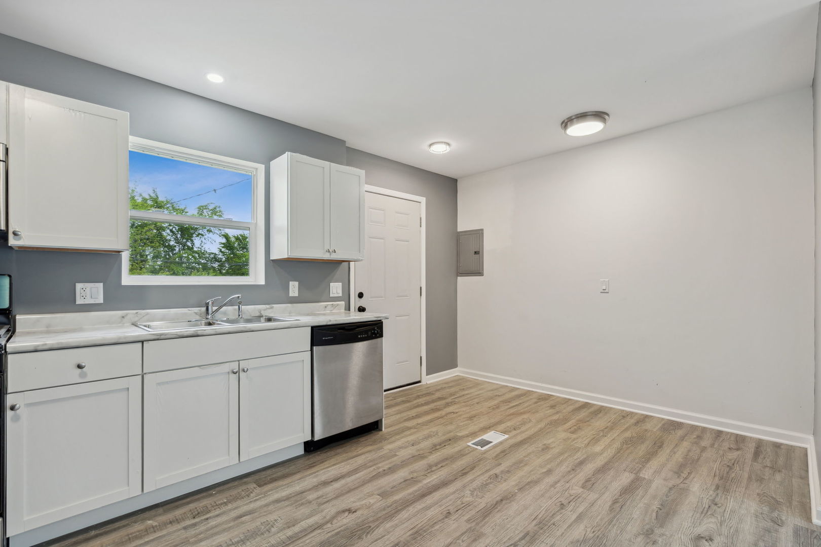Undisclosed Address Chicago Heights, IL 60411 - Photo 13 of 20 a kitchen with sink cabinets and wooden floor