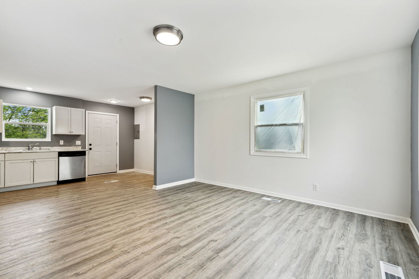 Undisclosed Address Chicago Heights, IL 60411 - Photo 14 of 20 a view of an empty room with a window and wooden floor