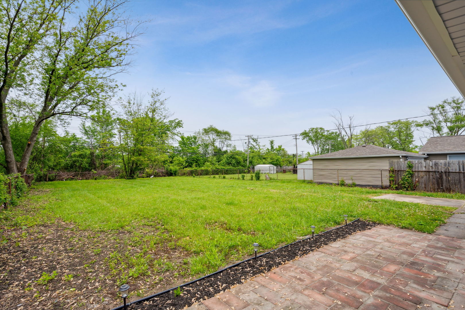 Undisclosed Address Chicago Heights, IL 60411 - Photo 18 of 20 a view of a backyard with potted plants and large tree