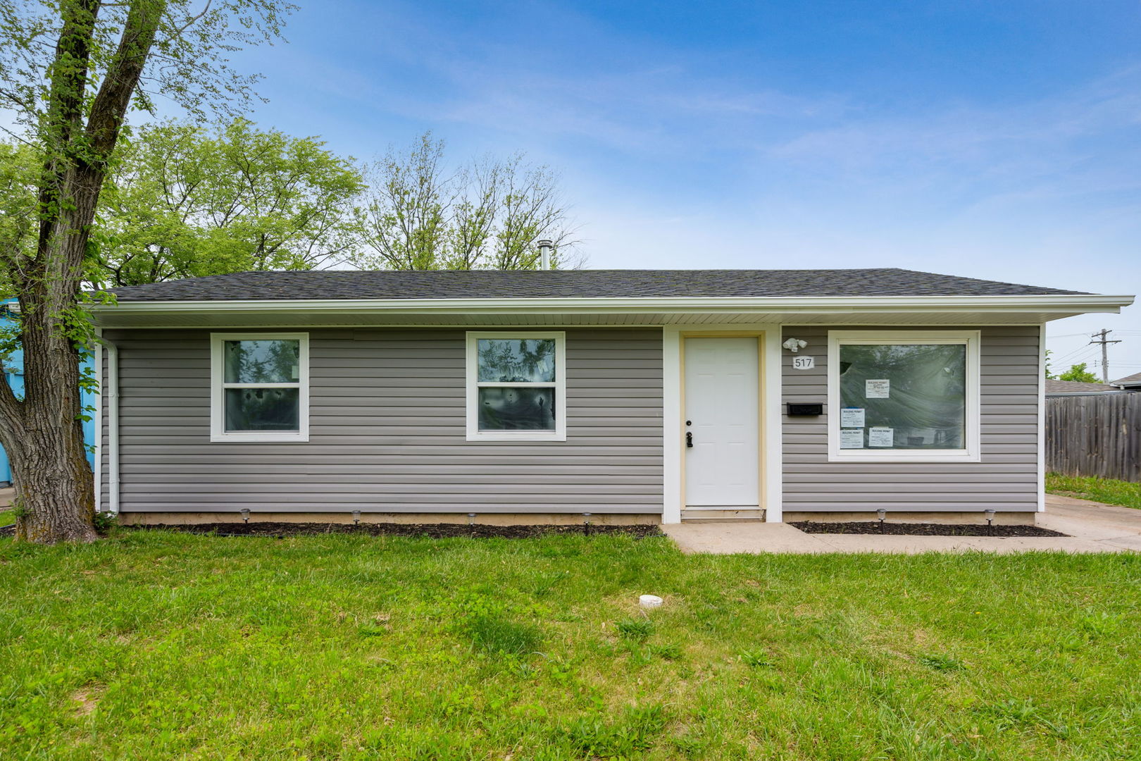 Undisclosed Address Chicago Heights, IL 60411 - Photo 2 of 20 a front view of a house with a garden