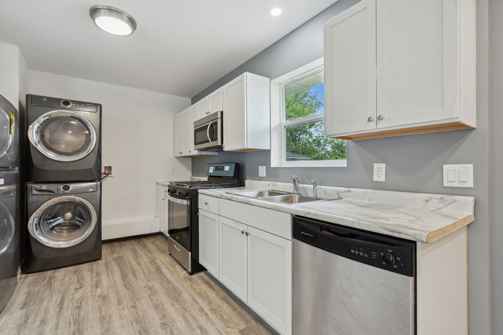 Undisclosed Address Chicago Heights, IL 60411 - Photo 10 of 20 a kitchen with kitchen island granite countertop a sink a stove and cabinets