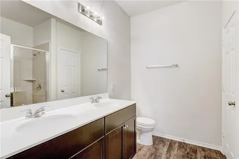 a bathroom with a sink a toilet and a mirror