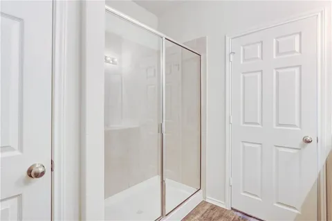a bathroom with a glass shower door