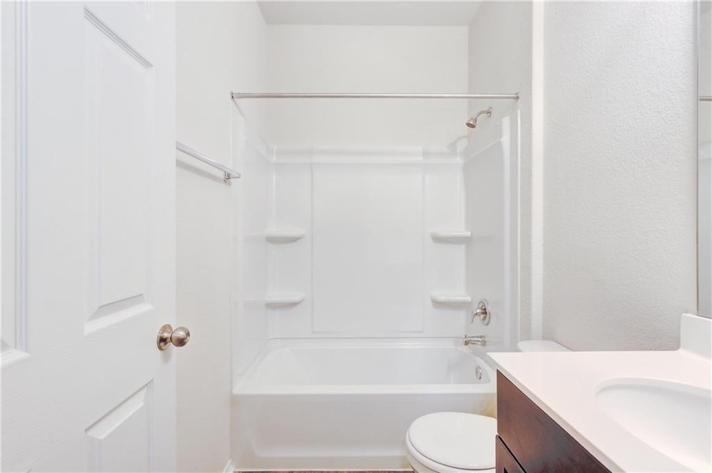 412 Ibis Falls Loop Jarrell, TX 76537 - Photo 17 of 28 a bathroom with a sink toilet and bathtub
