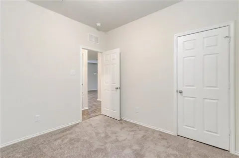 an empty room with closet area