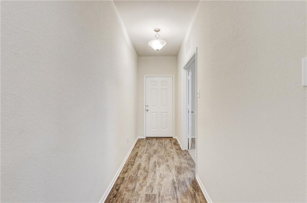 412 Ibis Falls Loop Jarrell, TX 76537 - Photo 4 of 29 foyer as you enter the home. Home has vinyl plank flooring throughout/carpet in bedrooms only.