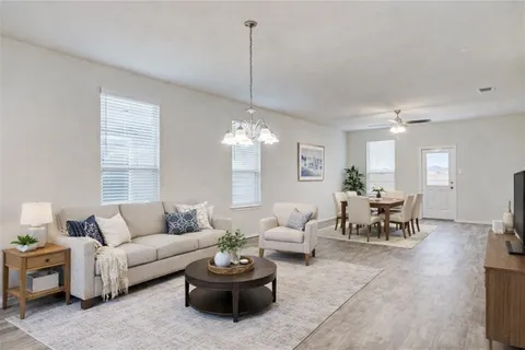 a living room with furniture and a chandelier